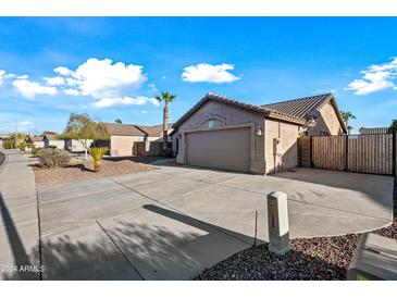 House exterior with driveway and desert landscaping at 13253 W Paradise Ln, Surprise, AZ 85374