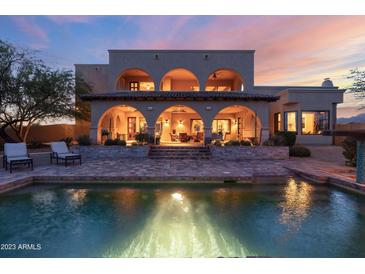 Luxury estate at dusk, featuring a large pool and expansive patio at 30316 N 139Th St, Scottsdale, AZ 85262