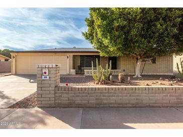 Ranch-style home with a well-maintained yard and desert landscaping at 666 N 65Th Pl, Mesa, AZ 85205