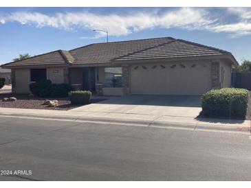 Single-story home with tile roof, two-car garage, and landscaped front yard at 11557 E Kilarea Ave, Mesa, AZ 85209