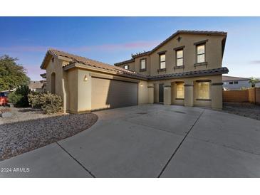 Two-story house with a large driveway and landscaped front yard at 45492 W Starlight Dr, Maricopa, AZ 85139