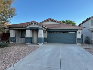 Single-story home with a two-car garage and desert landscaping at 633 E Leslie Ave, San Tan Valley, AZ 85140