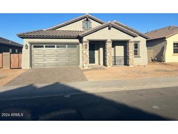One-story home with gray exterior, two-car garage, and stone accents at 3290 W San Cristobal Rd, San Tan Valley, AZ 85144