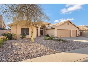 Single-story home with desert landscaping and two-car garage at 1325 W Muirwood Dr, Phoenix, AZ 85045