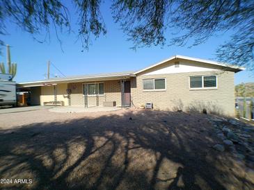 Ranch style home with covered patio and mature trees at 1368 E Victoria View St, Queen Valley, AZ 85118