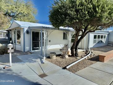 Front view of a single story home with covered patio and landscaping at 17200 W Bell Rd # 2204, Surprise, AZ 85374