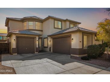 Two-story house with a three-car garage and landscaped yard at 25719 W Victory St, Buckeye, AZ 85326