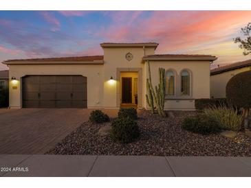 Single-story home with a two-car garage and desert landscaping at 814 E Fruit Stand Way, Queen Creek, AZ 85140