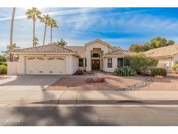 Single-story home with tile roof, two-car garage, and desert landscaping at 14543 W Bison Path, Surprise, AZ 85374