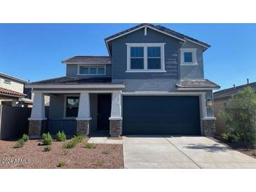 Two-story house with gray siding, white trim, and a two-car garage at 20955 W Hubbell St, Buckeye, AZ 85396