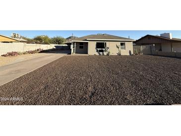 Ranch style home with a large front yard and gravel landscaping at 32 W Eva St, Phoenix, AZ 85021