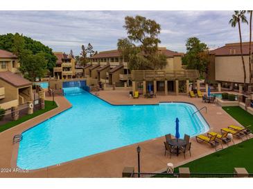 Inviting community pool with surrounding patio furniture at 1331 W Baseline Rd # 329, Mesa, AZ 85202