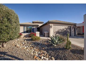 Single-story home with a two-car garage and desert landscaping at 27238 W Mohawk Ln, Buckeye, AZ 85396