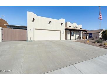 Spanish style home with a large driveway and mature landscaping at 10188 E La Palma Ave, Gold Canyon, AZ 85118