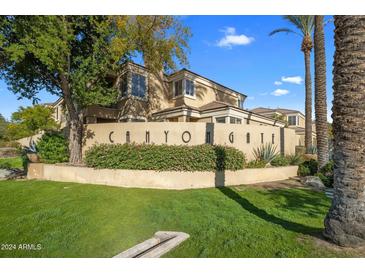 Canyon Gate community exterior featuring Spanish-style architecture and lush landscaping at 7887 N 16Th St # 116, Phoenix, AZ 85020