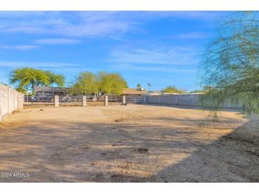 Backyard with horse stalls enclosed by a metal fence and a cinderblock wall at 2931 E Danbury Rd, Phoenix, AZ 85032