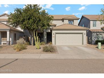 Two-story house with a beige exterior, two-car garage, and landscaping at 358 E Goldmine Ct, San Tan Valley, AZ 85140