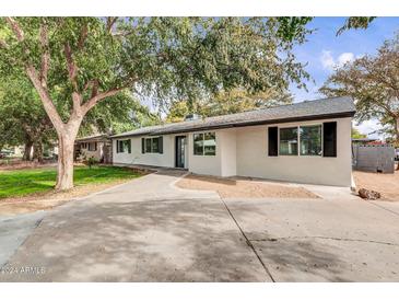 Newly renovated home with a modern facade and well-manicured lawn at 7701 N 17Th Ave, Phoenix, AZ 85021