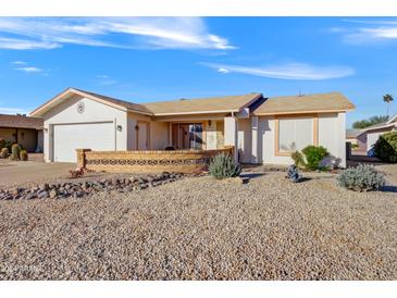 Single-story home with a two-car garage and desert landscaping at 7920 E Frito Dr, Mesa, AZ 85208