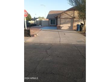 Single-story home with a driveway and landscaped yard at 1005 W Elena Cir, Mesa, AZ 85210