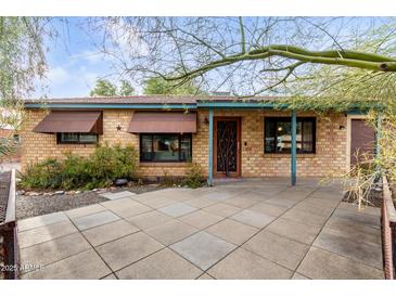 Brick home with a landscaped front yard and covered entryway at 7538 N 17Th Dr, Phoenix, AZ 85021