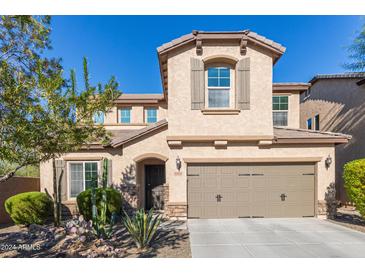 Two-story house with desert landscaping and two-car garage at 1864 W Buckhorn Trl, Phoenix, AZ 85085
