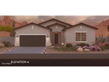 Single-story home with a two-car garage and landscaping at 18763 N Avelino Dr, Maricopa, AZ 85138