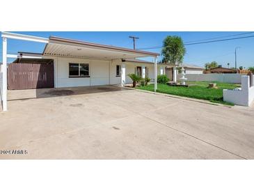 House exterior with carport and landscaped yard at 6306 W Mitchell Dr, Phoenix, AZ 85033