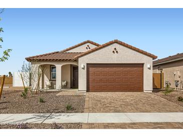 Single-story home with a brown garage door and landscaped front yard at 15658 W Winslow Ave, Goodyear, AZ 85338