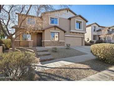 Two-story house with stone accents and a landscaped front yard at 15611 W Cameron Dr, Surprise, AZ 85379