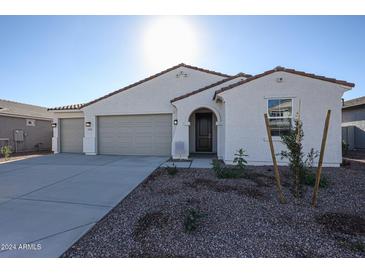 Single-story house with two-car garage and landscaped front yard at 35645 W Mallorca Ave, Maricopa, AZ 85138