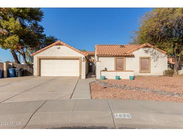 Single-story home with tile roof, attached garage, and landscaped front yard at 1920 E Palomino Dr, Tempe, AZ 85284