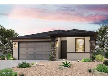 Single-story home with gray garage door and stone accents at 35605 W Mallorca Ave, Maricopa, AZ 85138