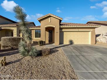 One-story home with a two-car garage and desert landscaping at 40728 N Hudson Trl, Anthem, AZ 85086