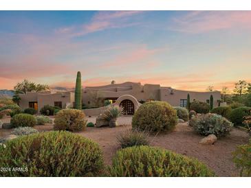 Stunning Southwestern-style home with desert landscaping at sunset at 11942 N Vista Del Oro --, Fort McDowell, AZ 85264