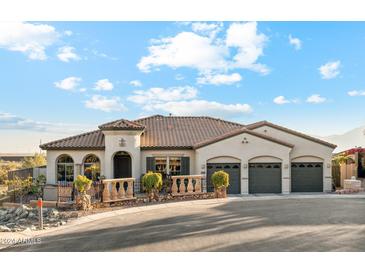 Single-story home with three-car garage, landscaping, and mountain views at 2705 W Wildwood Dr, Phoenix, AZ 85045