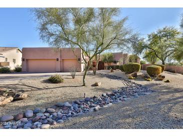 Desert landscape front yard with rock pathway and two-car garage at 29228 N 70Th Way, Scottsdale, AZ 85266