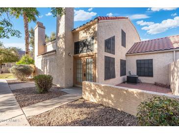 Tan stucco exterior with a tile roof and walkway at 602 N May St # 37, Mesa, AZ 85201