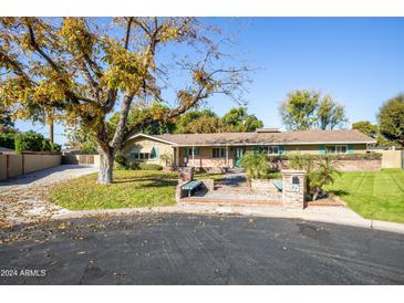 Attractive ranch home with mature landscaping and a large front yard at 618 W Palmaire Ave, Phoenix, AZ 85021