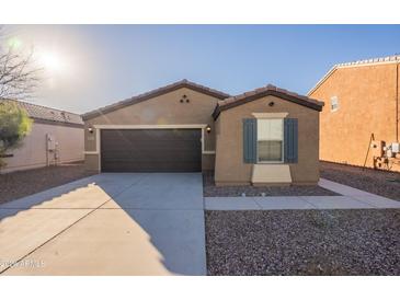 Single-story house with a two-car garage and desert landscaping at 9098 S 256Th Ln, Buckeye, AZ 85326