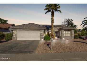 Charming single-story home with stone accents, a two-car garage, and desert landscaping at 16502 W Arroyo Ct, Surprise, AZ 85374