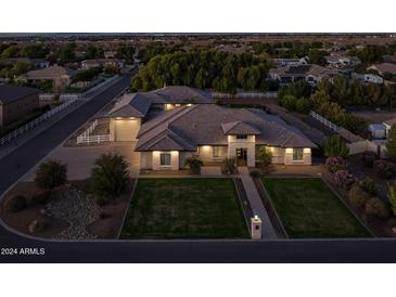 Beautiful property with a large yard, three-car garage, and upscale finishes at 21310 E Orchard Ln, Queen Creek, AZ 85142