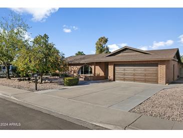 Single story home with a two-car garage and nicely landscaped front yard at 954 E Westchester Dr, Tempe, AZ 85283