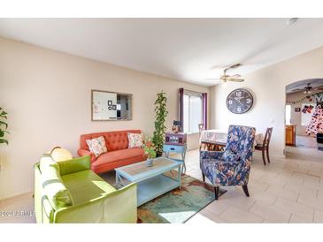 Bright living room with comfy seating and tile floors at 1034 E Monteleone St, San Tan Valley, AZ 85140