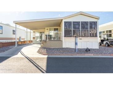 Mobile home with covered carport and spacious sunroom at 7750 E Broadway Rd # 795, Mesa, AZ 85208