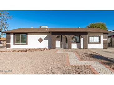 Updated single-story home with a landscaped front yard and walkway at 8840 W Desert Cove Ave, Peoria, AZ 85345