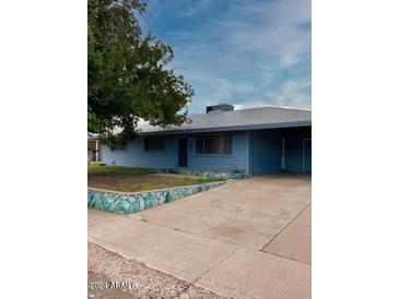Ranch style home with carport and a landscaped front yard at 345 W Essex Rd, Kearny, AZ 85137
