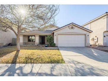 Single-story house with a two-car garage and well-maintained lawn at 555 W Racine Loop, Casa Grande, AZ 85122