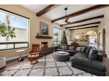 Cozy living room with a fireplace and large windows at 629 E Myrtle Ave, Phoenix, AZ 85020