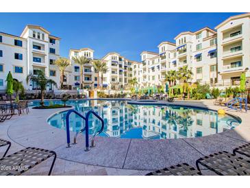 Resort-style pool and spa with surrounding patio and lounge chairs at 2511 W Queen Creek Rd # 340, Chandler, AZ 85248